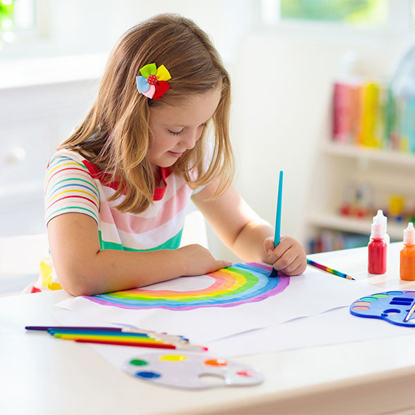 A girl doing art in a classroom